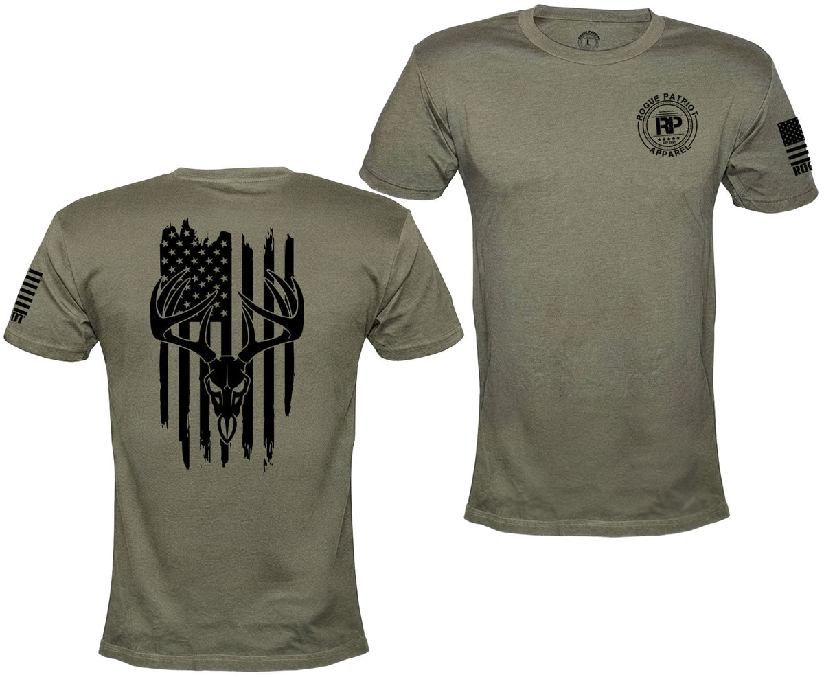 Front and back views of an olive green short-sleeve t-shirt. The back features a large black graphic of a deer skull with antlers integrated into a distressed American flag.