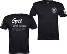 Black short-sleeve t-shirt shown from both front and back views. The back features a large white graphic reading 'Grit [grit] noun' with a dictionary definition underneath.