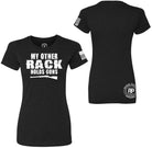 Black short-sleeve t-shirt shown from the front and back on a white background. The front features the white distressed text 'MY OTHER RACK HOLDS GUNS' with a rifle graphic, and the back has a circular 'Ridge Back Apparel' logo on the lower back and a small American flag print on the sleeve.