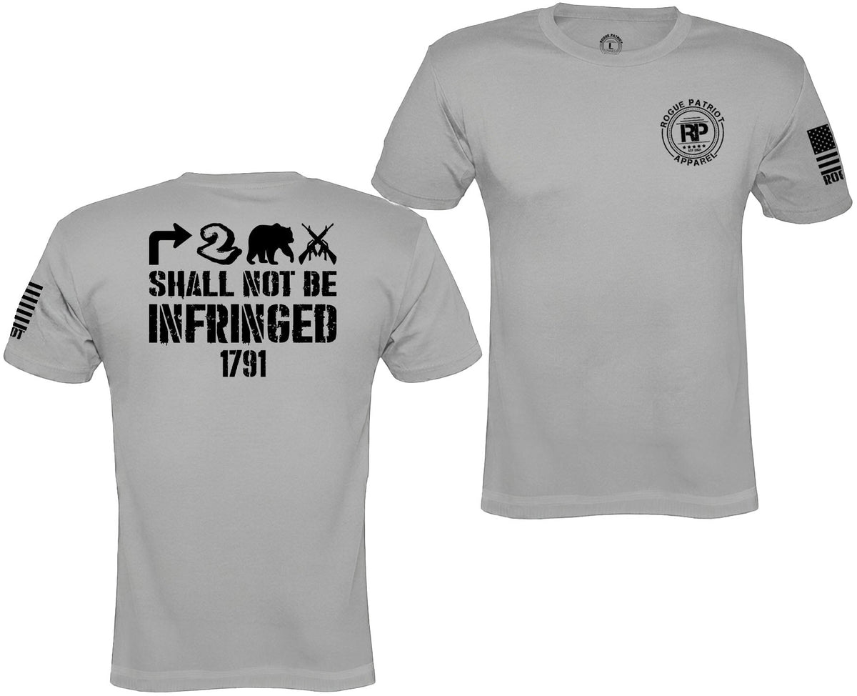 A light gray short-sleeve t-shirt shown from both front and back. The front features a circular 'Patriot Defense' logo on the left chest and a black flag graphic on the right sleeve.